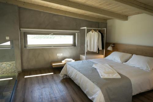 a bedroom with a large bed and a window at Iskios Villas in Agia Marina Nea Kydonias