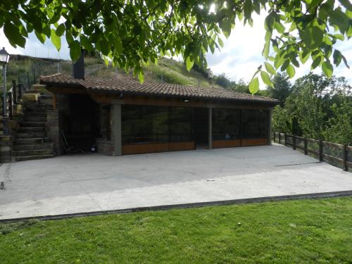 a building with a large patio in a yard at Apartaments El Tossalet in Bonansa