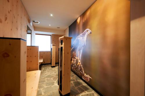 a wall with a painting of a giraffe on it at Alpenhotel Laurin in Hochgurgl