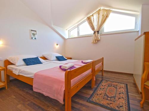 a bedroom with a large bed with a window at House Marcana 1156 in Marčana