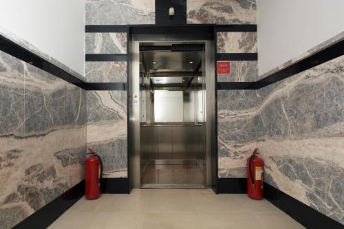 a elevator with two red fire hydrants in a building at Rooms Zvonimir in Split