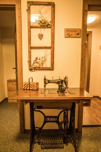 a sewing machine sitting on top of a wooden table at Rössingerhof in Ramsau am Dachstein