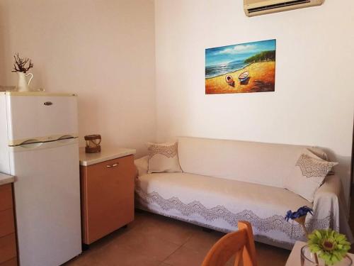 a kitchen with a refrigerator and a couch in a room at Maria's Apartments in Meyisti