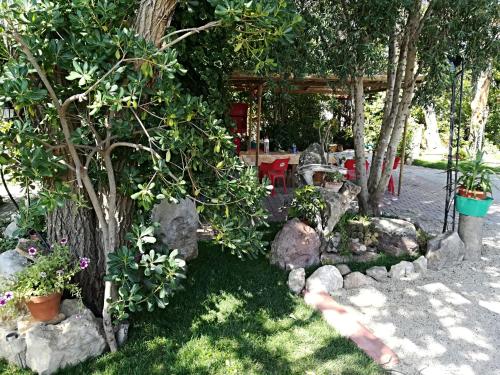 a garden with rocks and a table and a tree at B&B Domo De Pedra in Tottubella