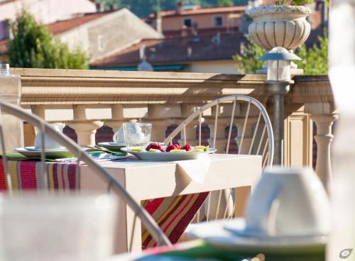 a table with plates of food on a balcony at B&B La Sosta degli Artisti in Pietrasanta