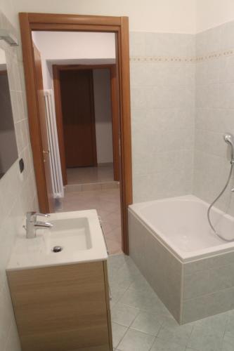 a bathroom with a sink and a tub and a toilet at Casa Valli in Lezzeno