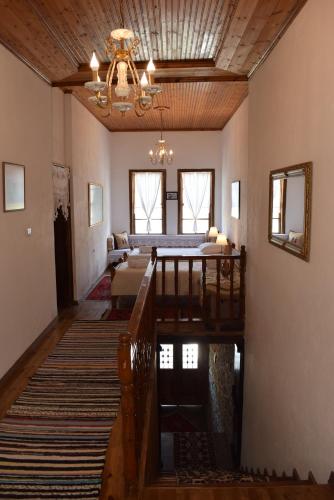 a living room with a bed and a chandelier at Hotel Gjirokastra in Gjirokastër
