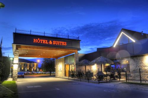 a hotel and suites building at night at L'Escale Hôtel Suites in Val-dʼOr