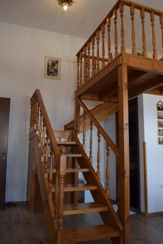 a wooden staircase in a home with wooden floors at Hotel Gjirokastra in Gjirokastër