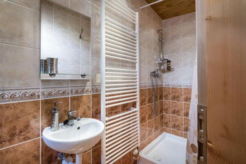 a bathroom with a sink and a shower and a toilet at Mária Kičáková TATRY MKS in Štrba