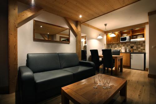 a living room with a couch and a table at Chalet des Neiges : La Cime Des Arcs in Arc 2000