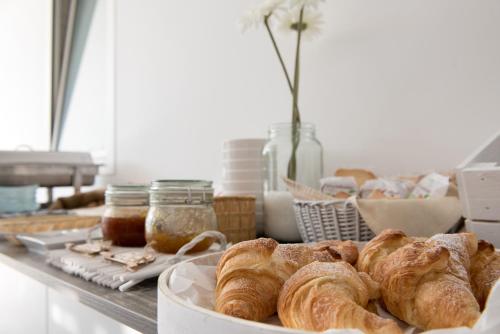 a table topped with a plate of croissants and other pastries at Relais Regina Rosanna in Gallipoli