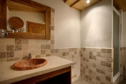 a bathroom with a wooden sink on a counter at Chalet des Neiges : La Cime Des Arcs in Arc 2000