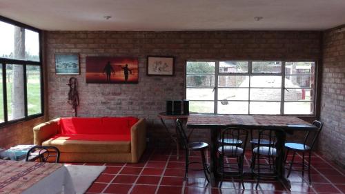 a living room with a couch and a table at Finca Saron Hostería & Spa in Sogamoso