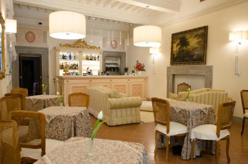 a restaurant with tables and chairs and a fireplace at Hotel San Michele in Cortona