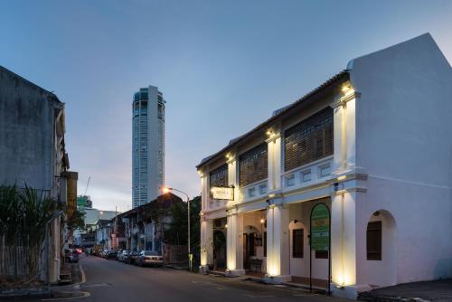 a building on a street with a tall building at Rope Walk Guest House in George Town
