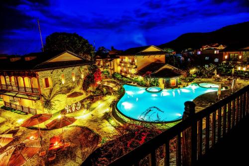 a view of a swimming pool at night at Temple Tree Resort & Spa in Pokhara