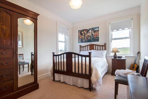 a bedroom with a bed and a dresser and a mirror at Garrane House in Croom