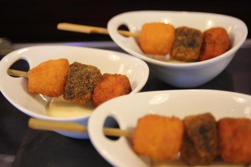 two bowls of food on a table with chopsticks at Hotel Conde Duque Bilbao in Bilbao