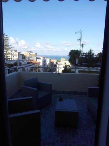 a balcony with couches and a view of the ocean at B&B Rosy in Paola