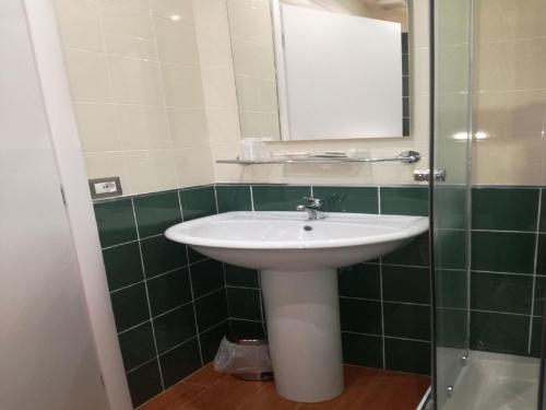 a bathroom with a white sink and a mirror at B&B Il Prugnolo in Castel di Sangro