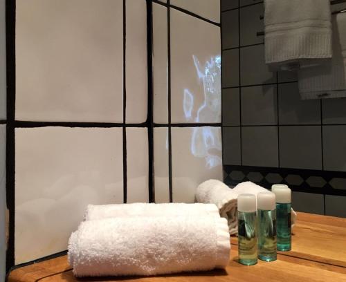 a pile of towels on a table in a bathroom at Kisa Wärdshus & Hotell in Kisa