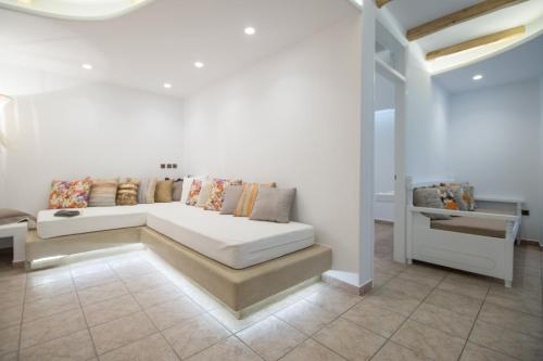 a white bed with pillows on it in a room at Spiros in Naxos Chora