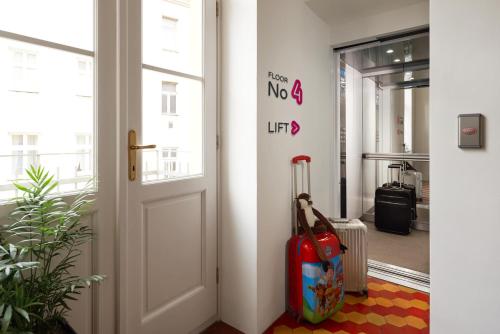 an open door with two suitcases in a hallway at Residence Vocelova in Prague