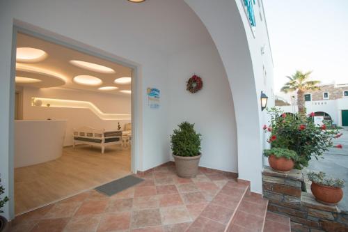 a hallway with potted plants in a building at Spiros in Naxos Chora