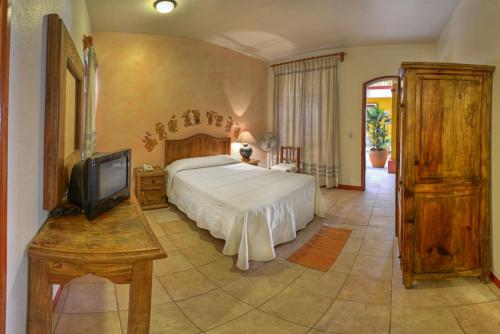 Un pat sau paturi într-o cameră la Hotel Posada Catarina