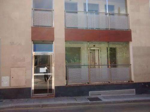 a person is standing in the window of a building at Apartamento Turistico Dct. Creus in Guadalajara