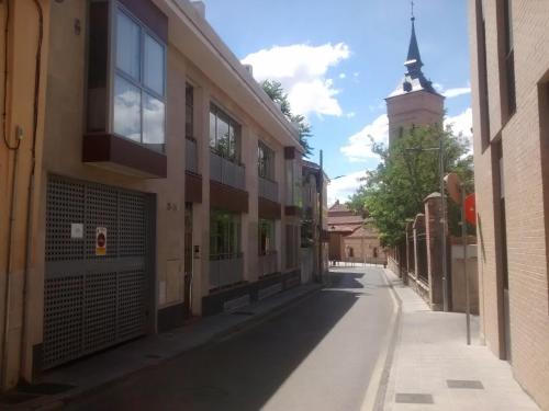 an empty street with a building and a tower at Apartamento Turistico Dct. Creus in Guadalajara