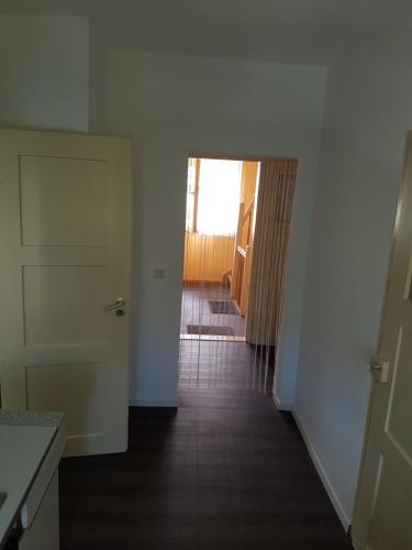 an empty room with a door and a hallway at Schöne, private Wohnungen in Aalen