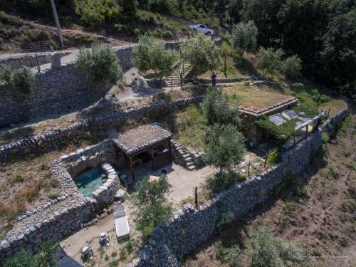 an aerial view of a stone building with a garden at Les Bergeries "Le figuier" in Omessa