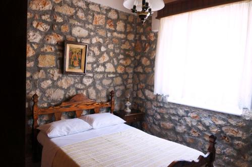 um quarto com uma cama e uma janela em Ktima Lazarata em Lazaráta