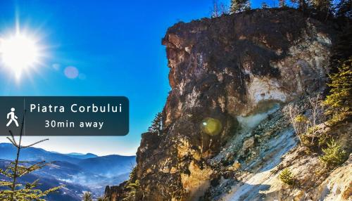 a rocky mountain with the sun in the background at Casa Petri Rosia Montana in Roşia Montană
