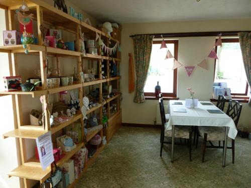 a room with a table and a table and shelves at Monturpie Guest House in Kirkton of Largo
