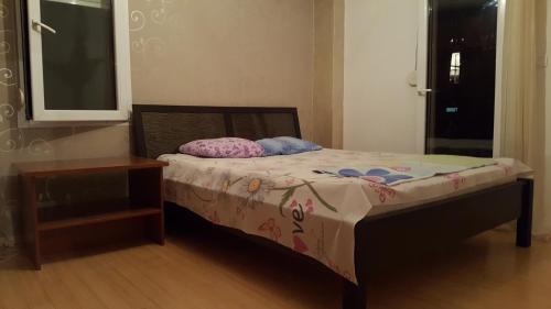 a small bed in a room with a night stand at Zebra in Podgorica