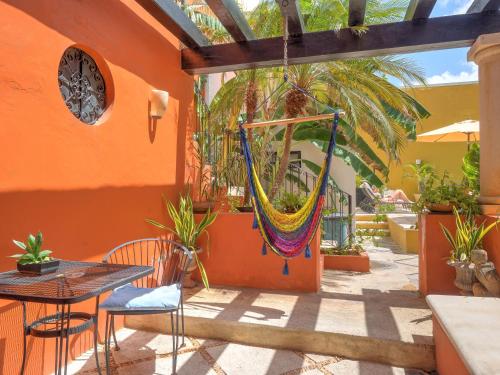 a patio with a hammock hanging from a building at Hotel Luz en Yucatan in Mérida