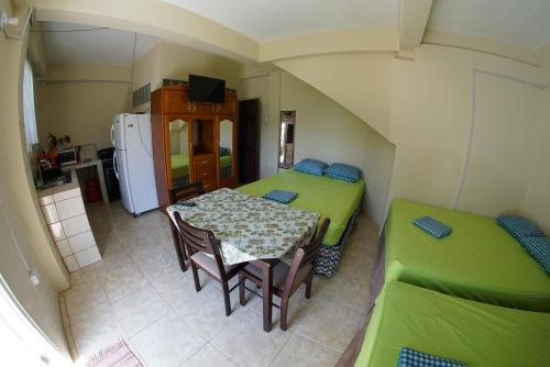 a room with two beds and a table and chairs at Our Sanctuary in Scarborough