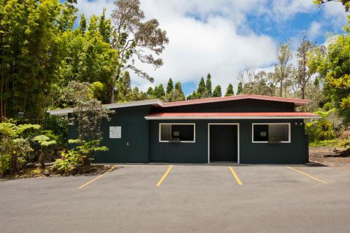 a green building with a parking lot at Hale 'Ohu Bed & Breakfast in Volcano