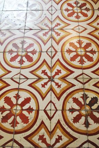 a close up of a tile floor with patterns on it at Hostal Españolete in Santa Marta