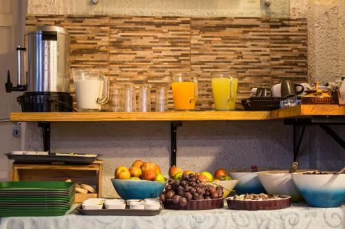 a table topped with bowls of fruit on a counter at Hostal Forestal in Santiago