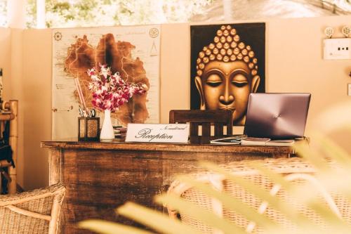 a desk with a laptop on top of it at Angkana Bungalows adults only in Thongsala