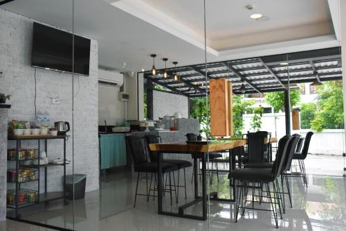 a dining room with a table and chairs in a kitchen at TUCK Me iN in Chiang Mai