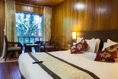 Tempat tidur dalam kamar di TSG Blue Resort & Spa