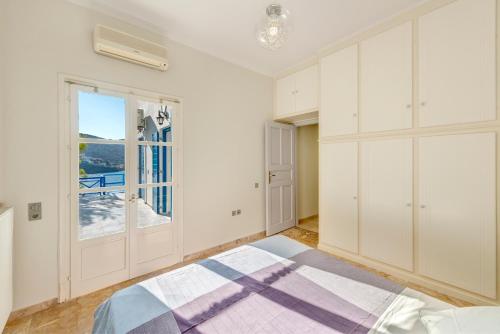 a bedroom with a bed and a window at Syros Private House with superb sea view in Kinion