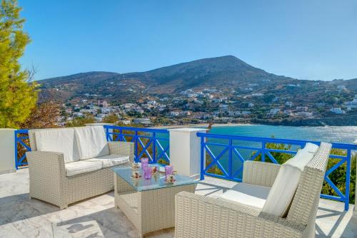 a patio with chairs and a table with a view at Syros Private House with superb sea view in Kinion