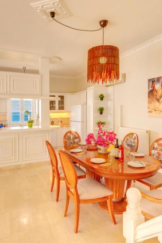 a dining room with a wooden table and chairs at Syros Private House with superb sea view in Kinion