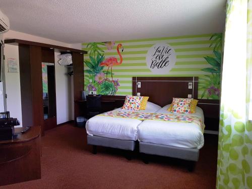 a bedroom with a bed and a flamingo wall at Boutique Hotel Novalis in Gradignan